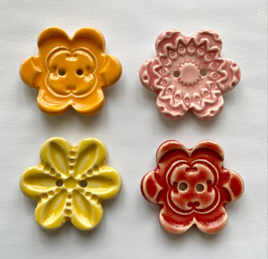 Set of four flower shaped ceramic handmade buttons