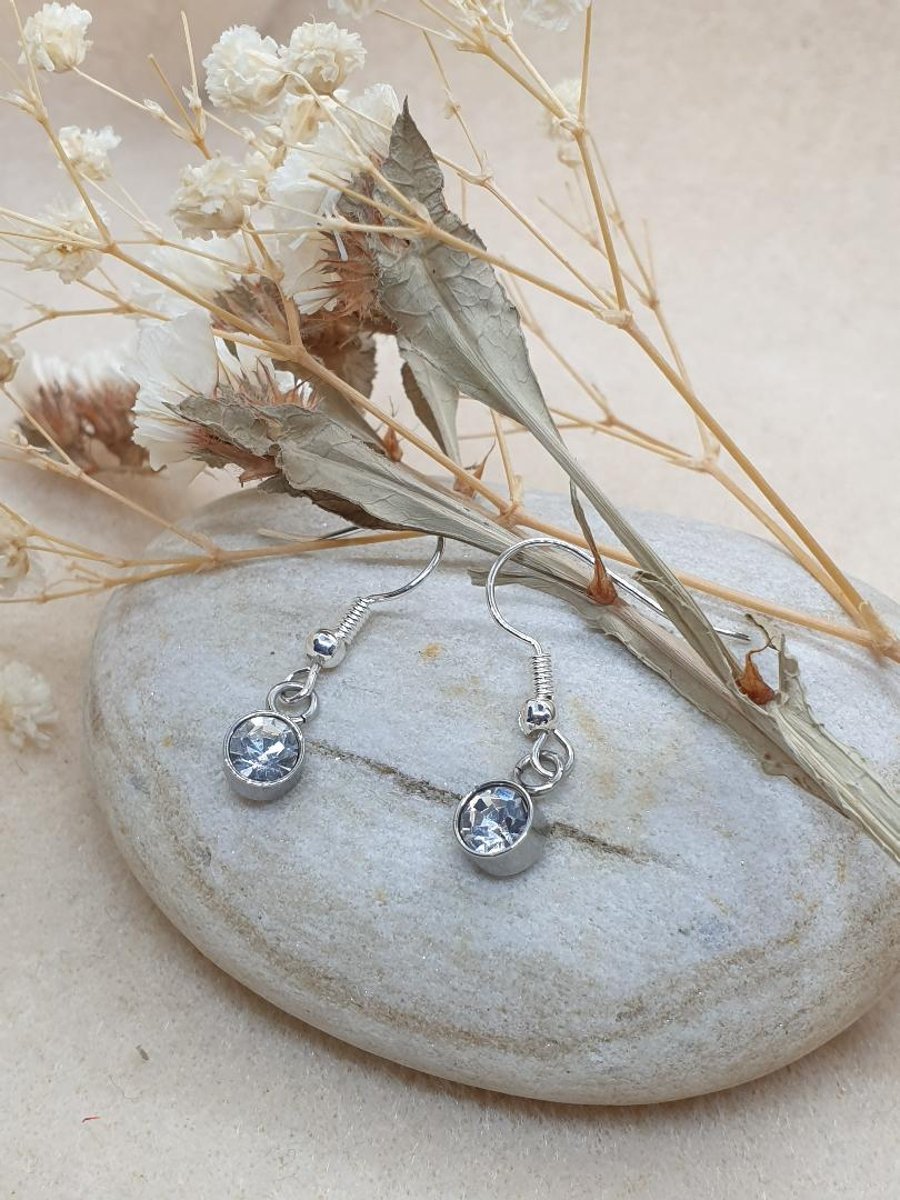 clear glass charms suspend on hypoallergenic silver plated earrings 