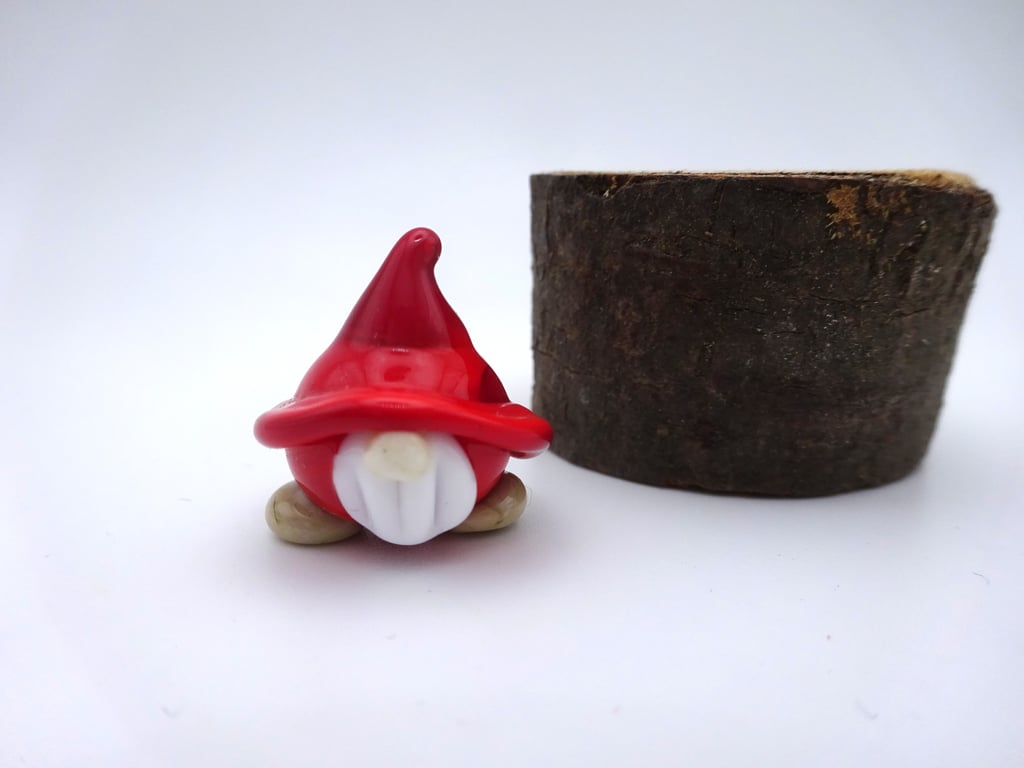 small red glass gnome figure