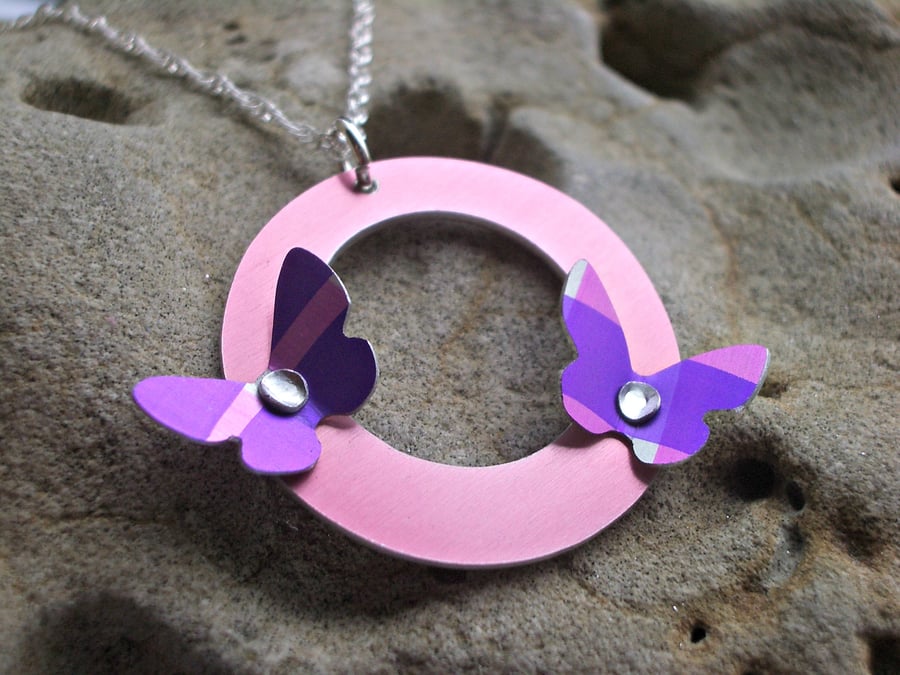 Purple and pink riveted butterflies on circle