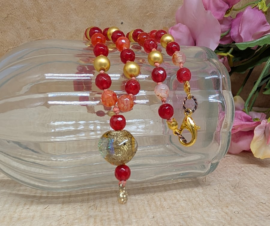 Orange agate and gold hematite knotted necklace with lamp work focal bead