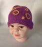 Children's hand knitted winter hat with circle details
