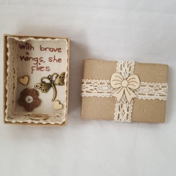 small miniature art diorama with a message 'with brave wings she flies'