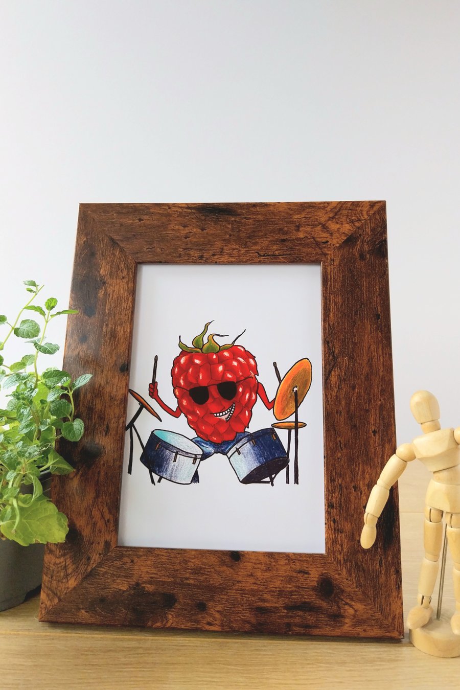 Illustration print of raspberry character playing the drums