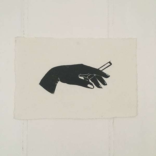 'Noir' linocut print femme fatale hand silhouette holding a cigarette.