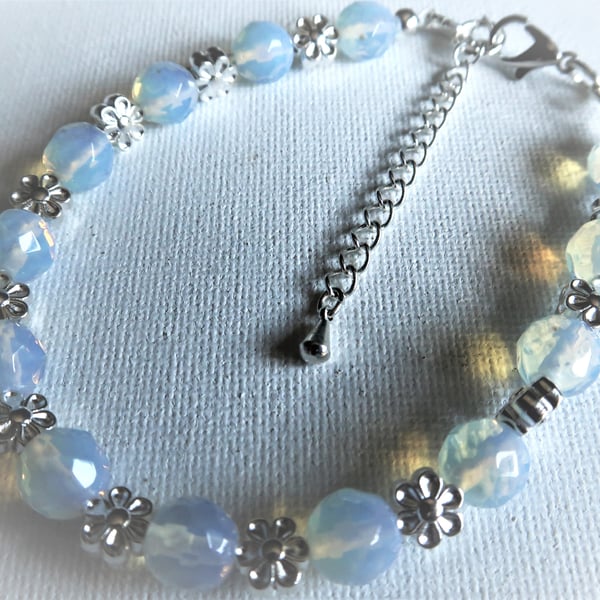 FACETED OPALITE CRYSTAL AND TIBETAN SILVER FLOWER BEADS.