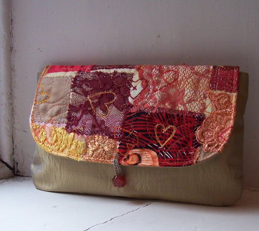 Clutch bag in antique gold with lace and silk