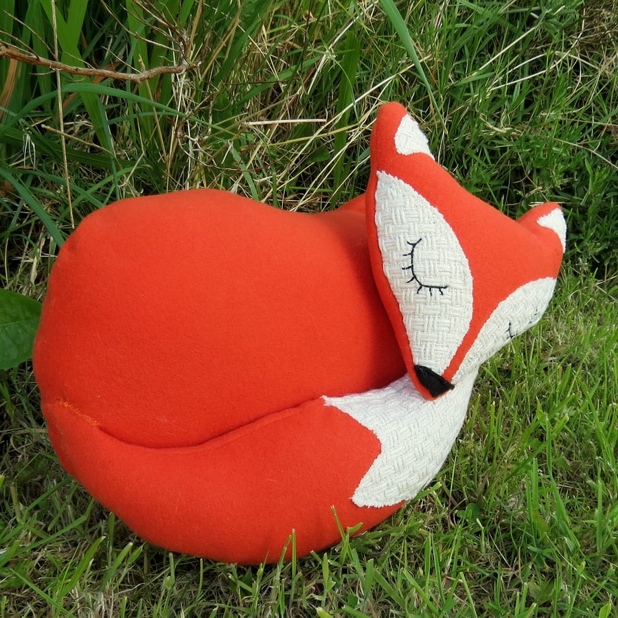 A snoozy fox cushion. 38cm in length. (15 inches)