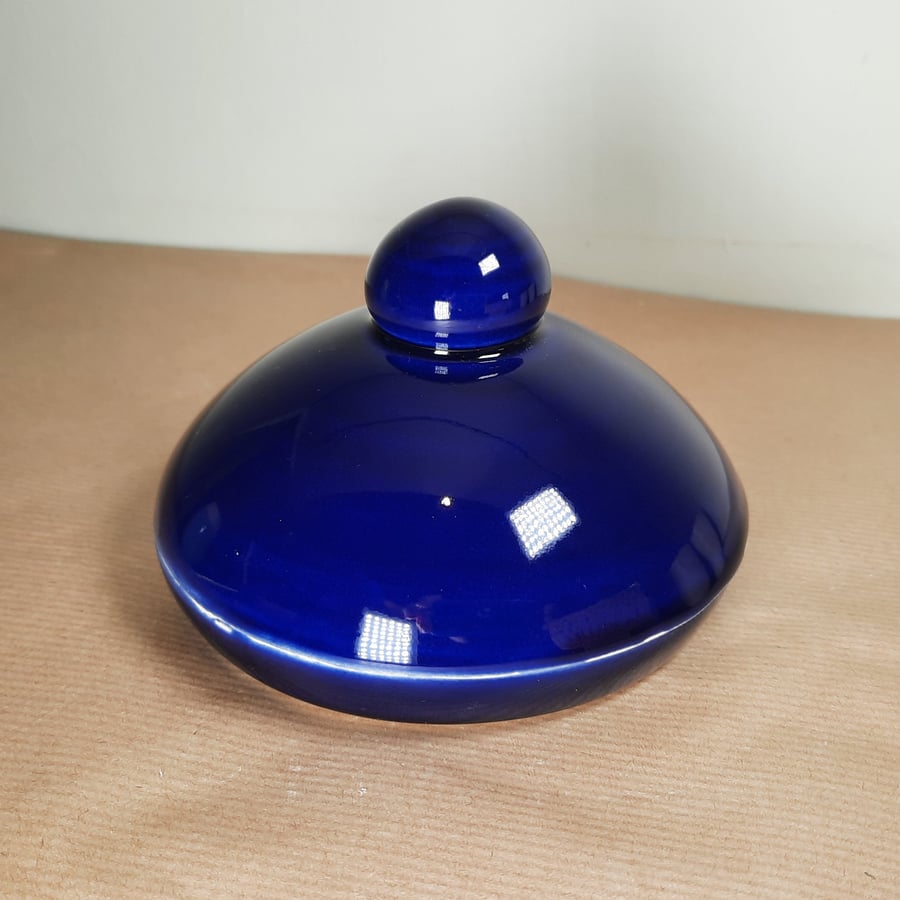 A hand thrown cobalt blue and white ceramic butter dish