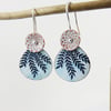 Two enamel on copper disc dangles with textured pattern and leaf design