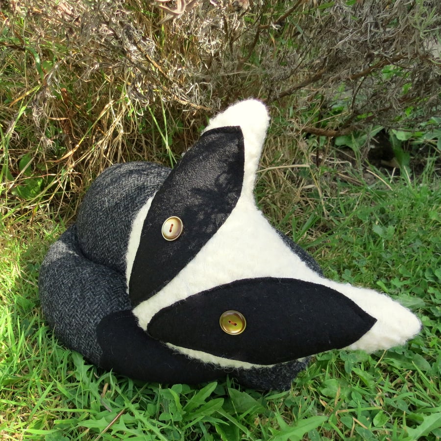 A soft and tactile badger cushion.  