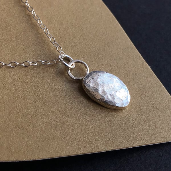 Recycled silver pendant with hammered finish.