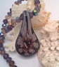 Purple Floral Patterned Glass Pendant on a Mixed Purple Crystal Necklace - Image 1