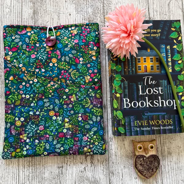 Fabric book sleeve with pocket for paperback books. Padded and fully lined. 