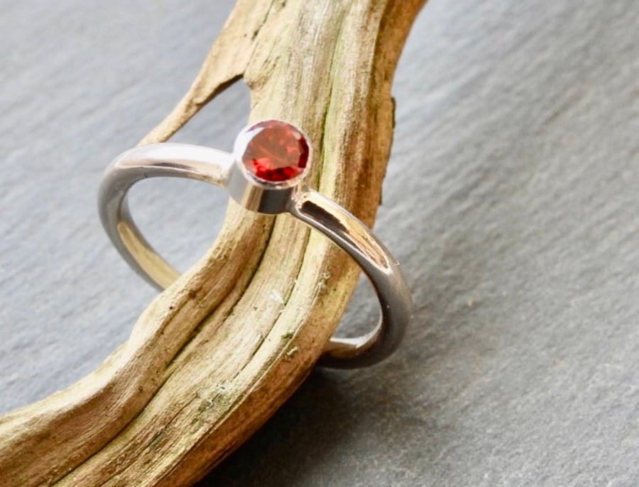 Stacking ring with a red CZ stone 