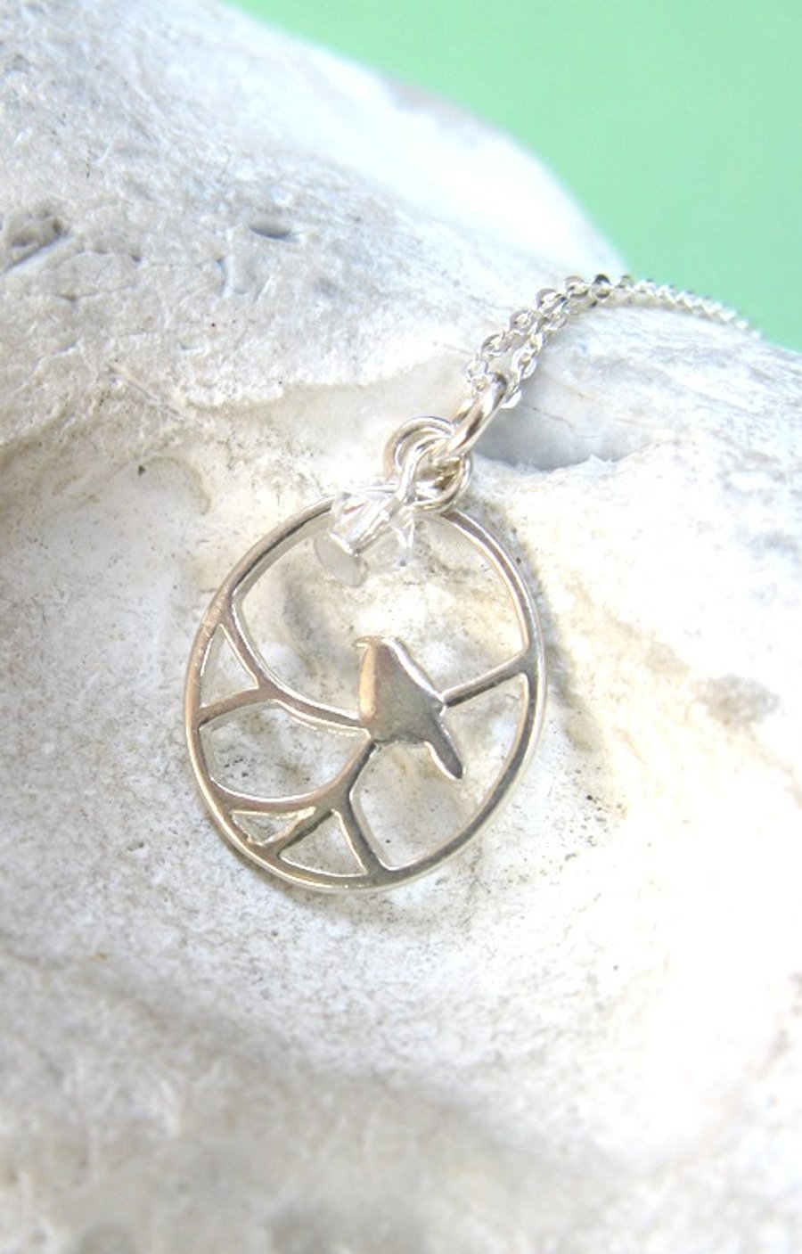 Tiny bird on branch necklace in sterling silver