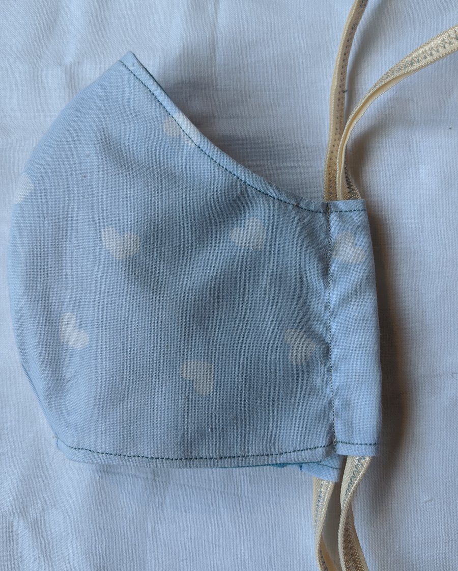 Face mask with baby blue heart pattern