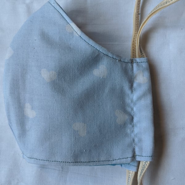Face mask with baby blue heart pattern