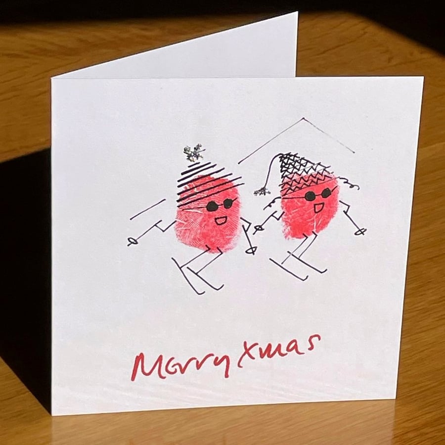Thumb-print skiers; colourful 13.5 cm square Christmas card, blank inside
