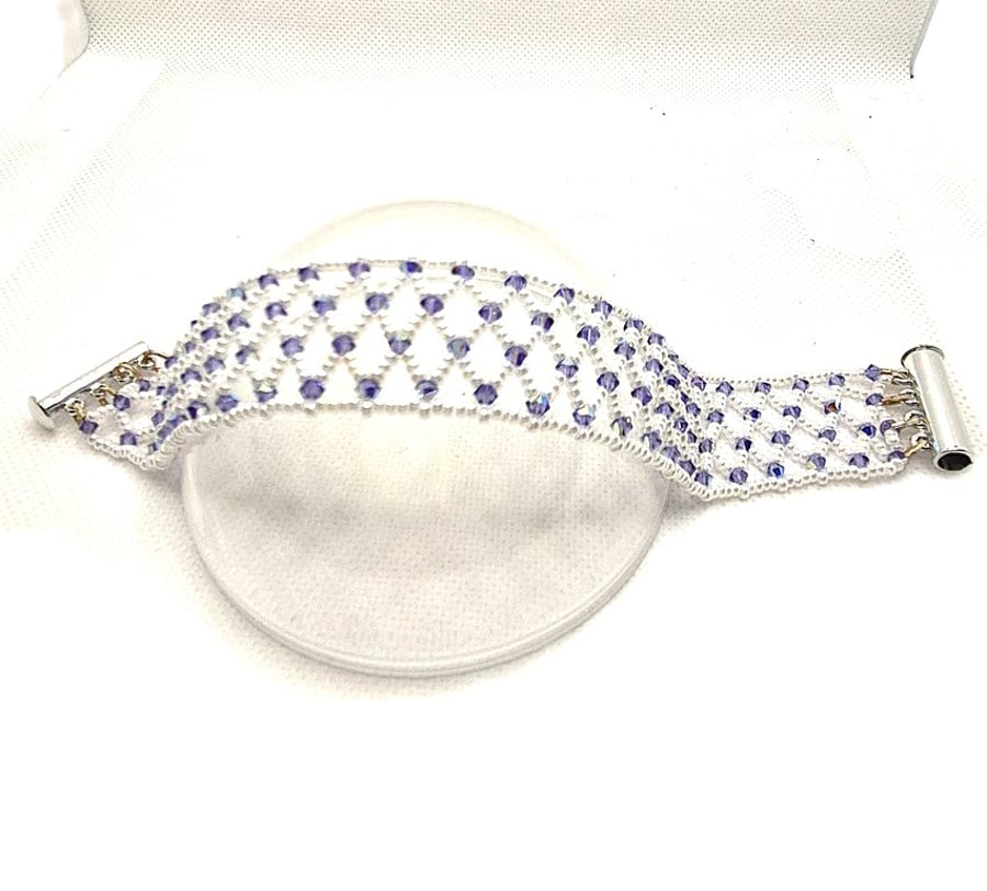 A seed bead netted bracelet with purple Swarovski crystals