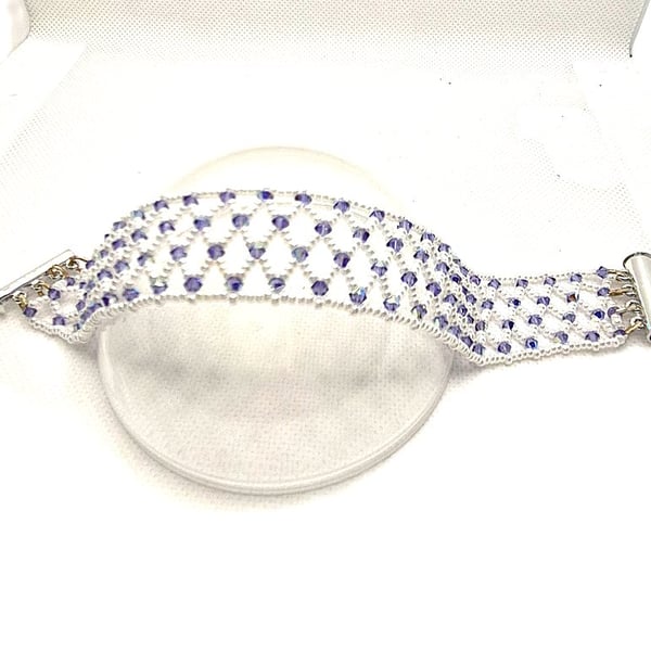 A seed bead netted bracelet with purple Swarovski crystals