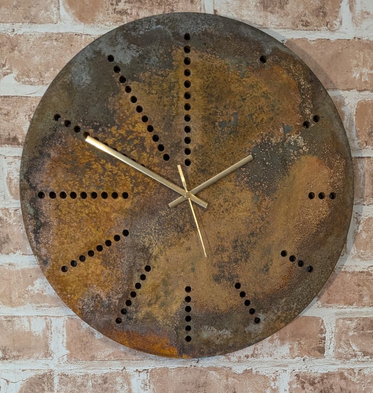 Rusting disc clock using holes as hour markers