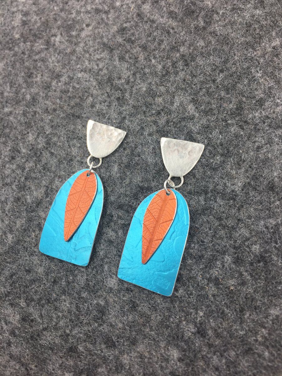 Handmade silver and aluminium textured earrings in turquoise and orange 