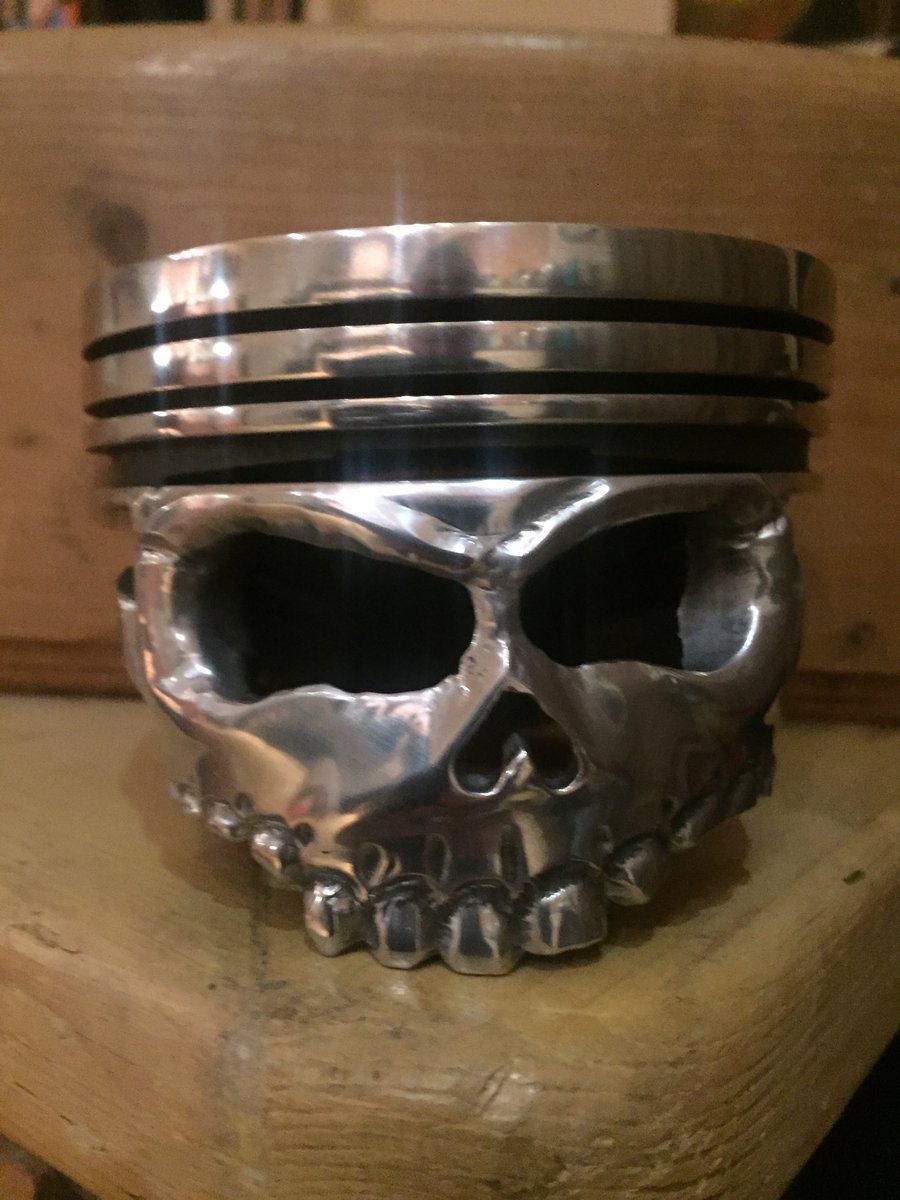 v8 piston from a classic car made into skull piston 
