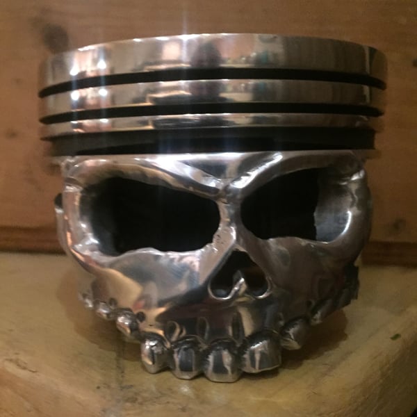 v8 piston from a classic car made into skull piston 