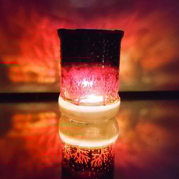 Glass painted handmade candle holder with late sunset and row of frosty trees