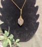 Beautiful wire wrapped pebble pendant on gold coloured chain. 