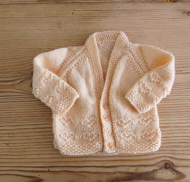 Handmade peach coloured v-necked baby cardigan age 0-3 months.