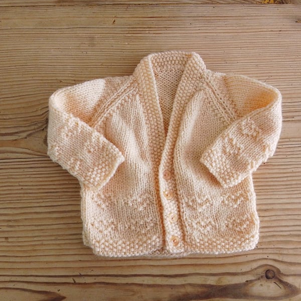 Handmade peach coloured v-necked baby cardigan age 0-3 months.