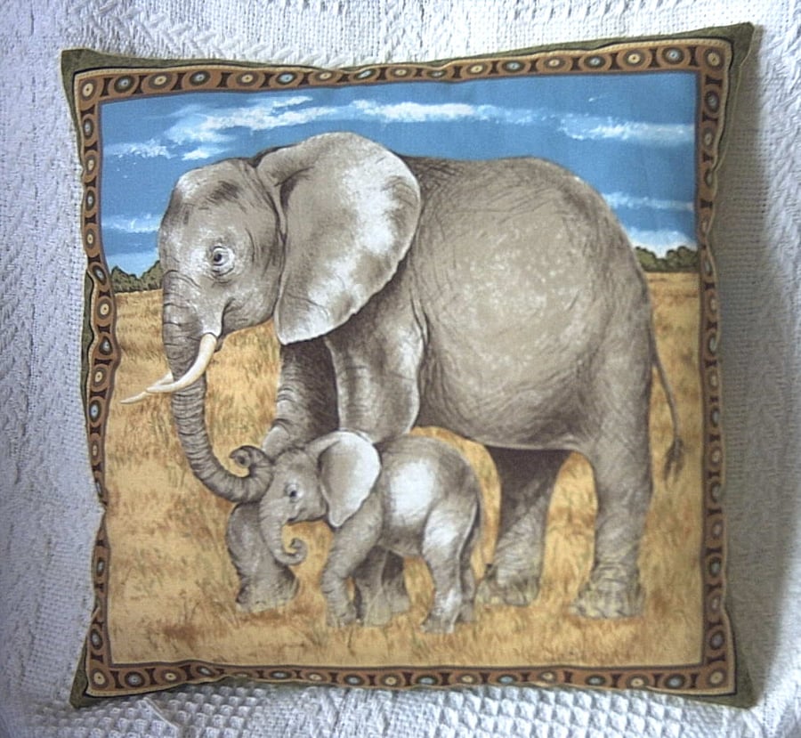 On Safari  Elephant and young  walking across a  grassy plain cushion