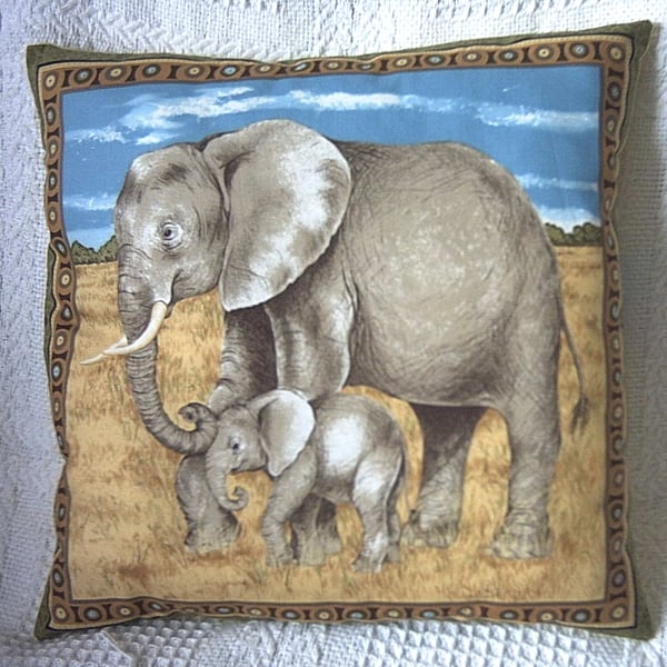 On Safari  Elephant and young  walking across a  grassy plain cushion