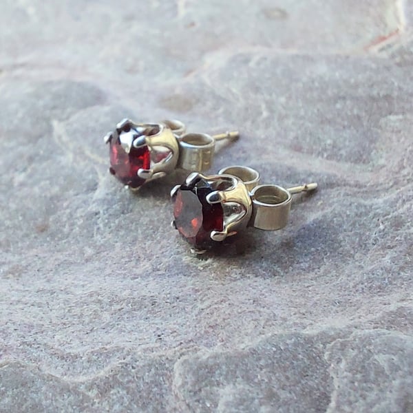 Sterling silver stud earrings with faceted garnet; January birthstone