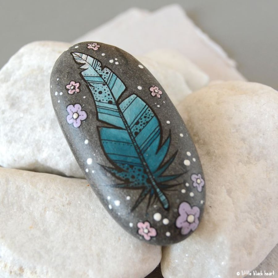 fancy blue feather - painted pebble