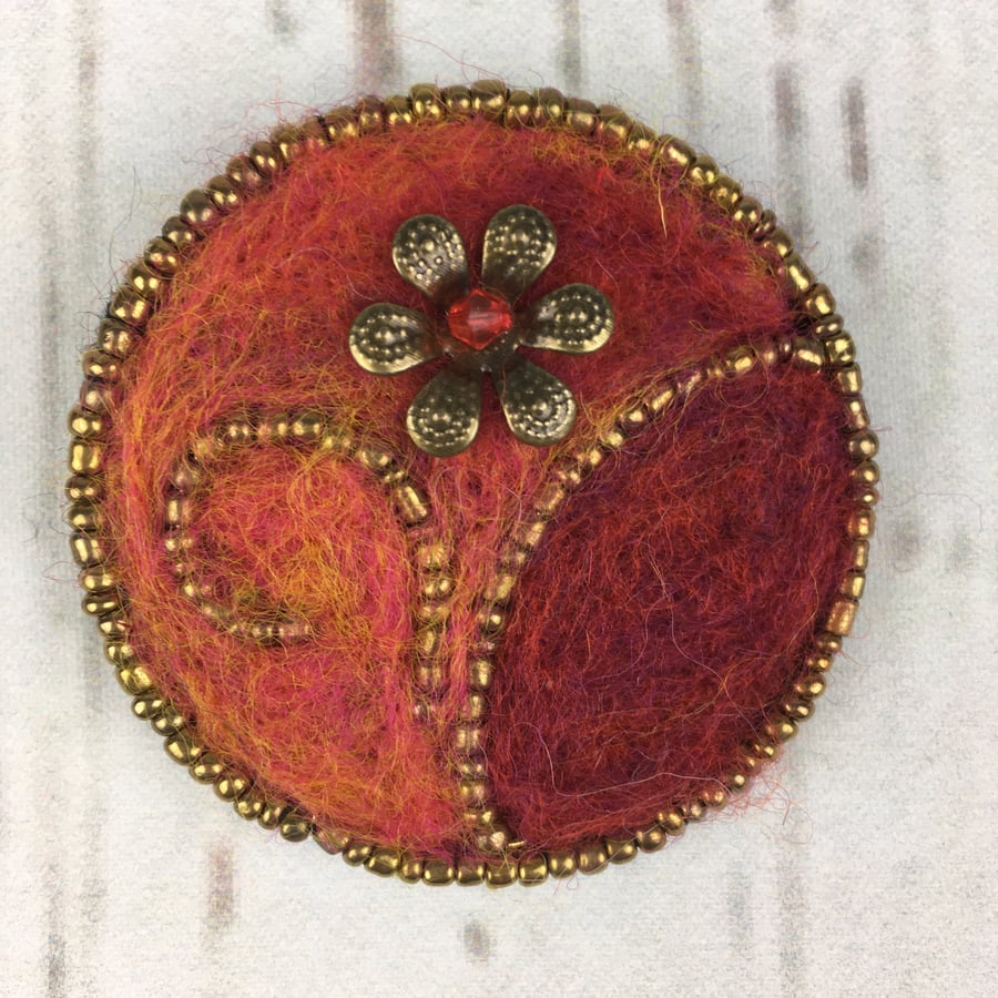 Beaded floral brooch with needle felting in red and orange