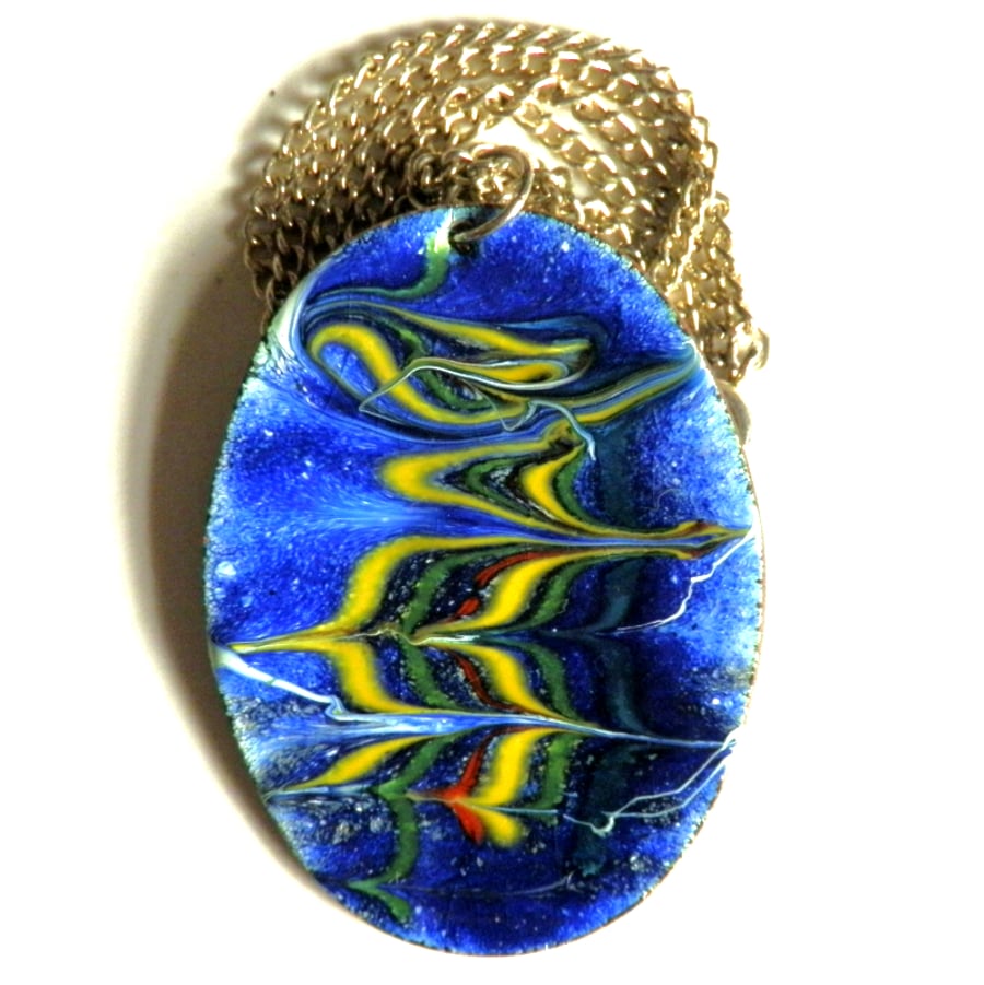 green, yellow, red scrolled over blue on white - pendant
