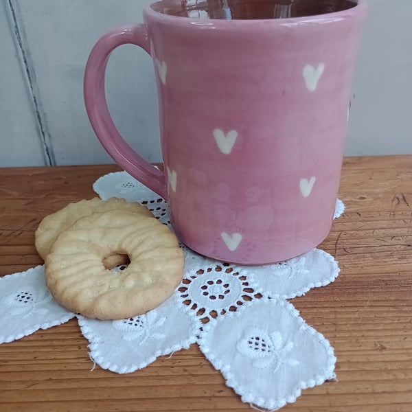 Pink mug with white heart design
