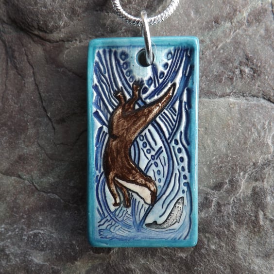 Handmade Ceramic Otter pendant in turquoise blue