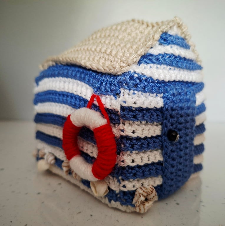 Crocheted beach hut with life ring and real shells