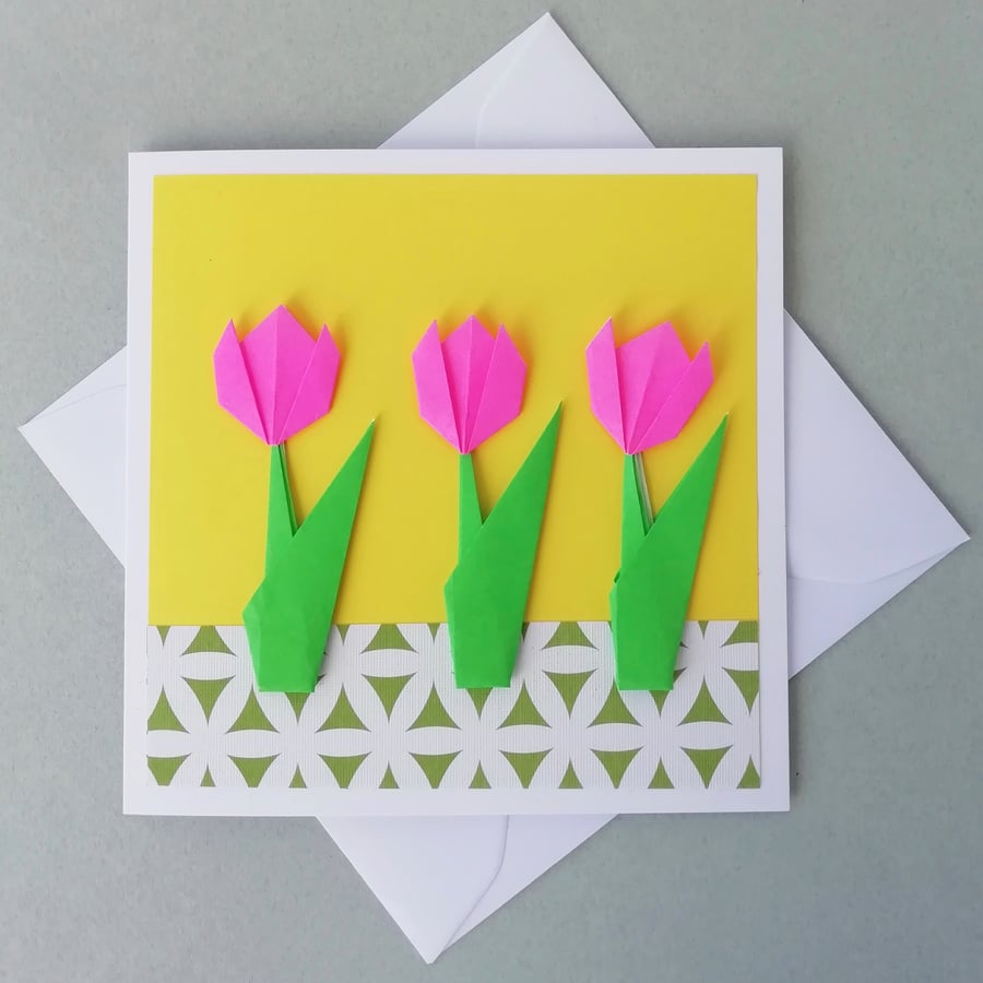 Pink tulips on a yellow greetings card
