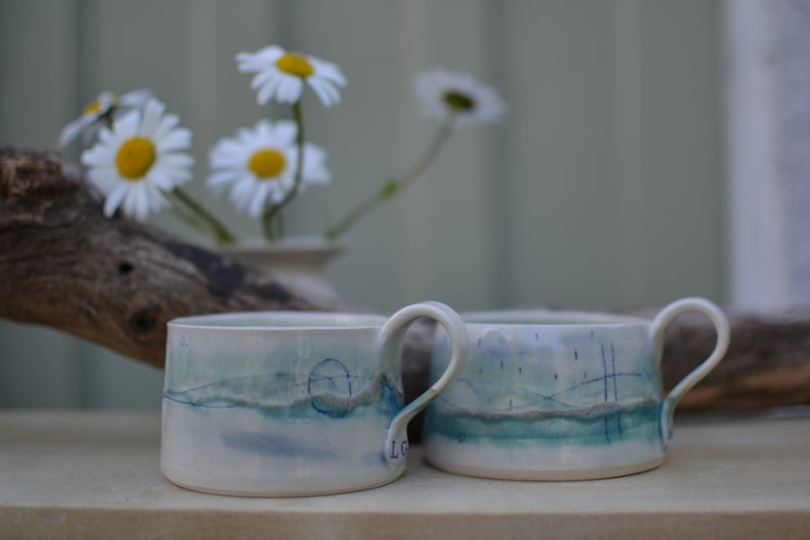 Seascape cup with green, white, turquoise and blue glaze