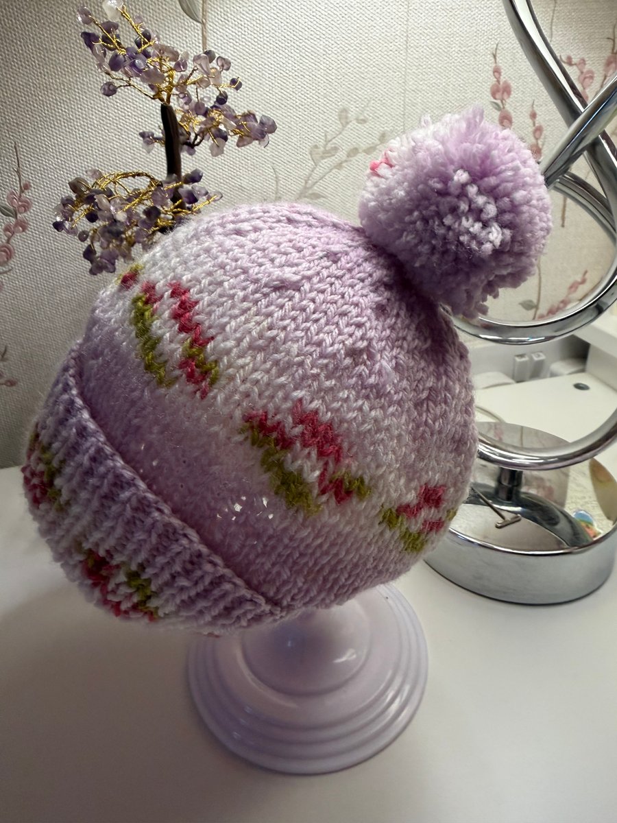 Hand knitted baby hat with rib and Pom Pom.