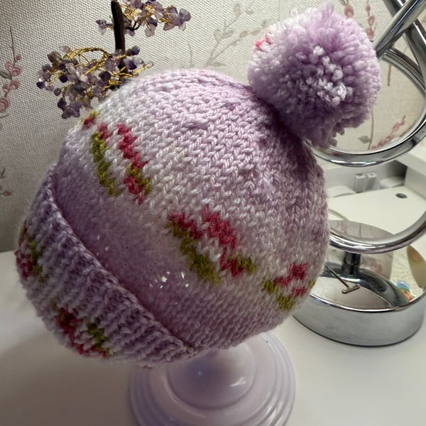 Hand knitted baby hat with rib and Pom Pom.