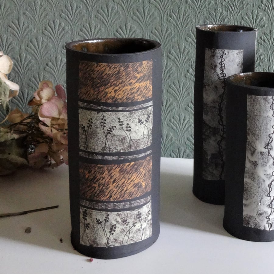 Leah. Black ceramic vase, lemon, grey and ochre with seeds and grass motifs.