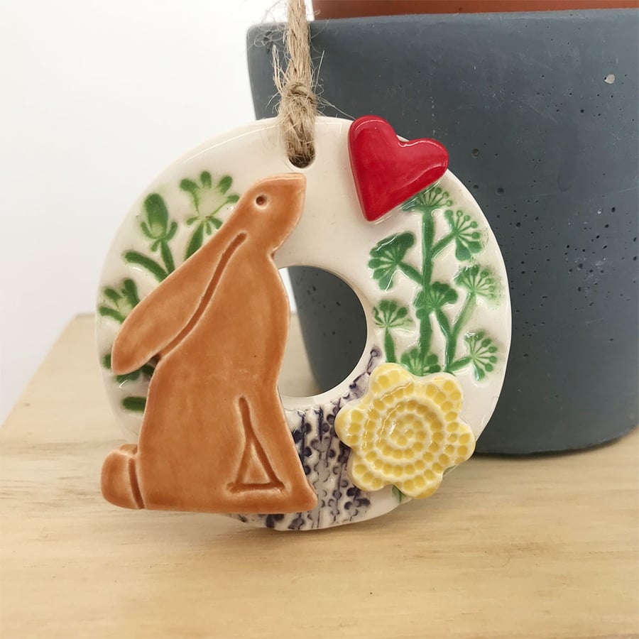 Small ceramic hare decoration with summer flowers