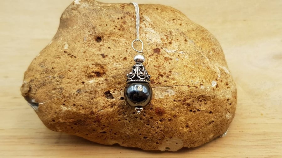 Minimalist Hematite cone pendant. Reiki jewellery