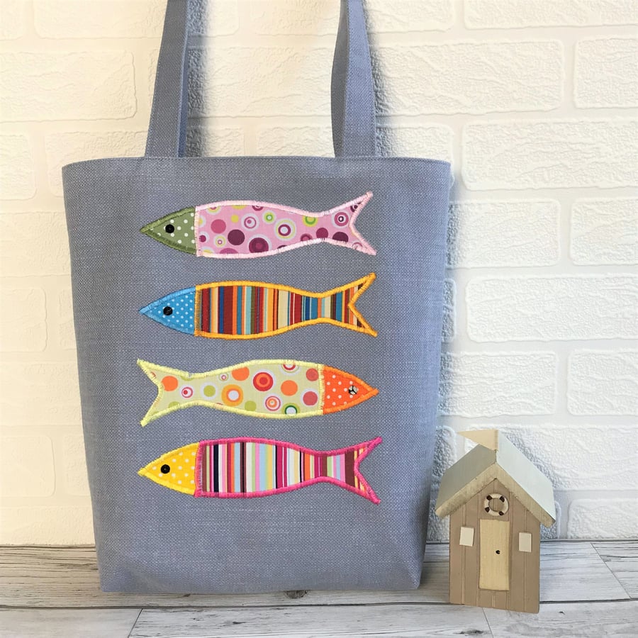 Fish tote bag in blue with four colourful circles and stripes patterned fish
